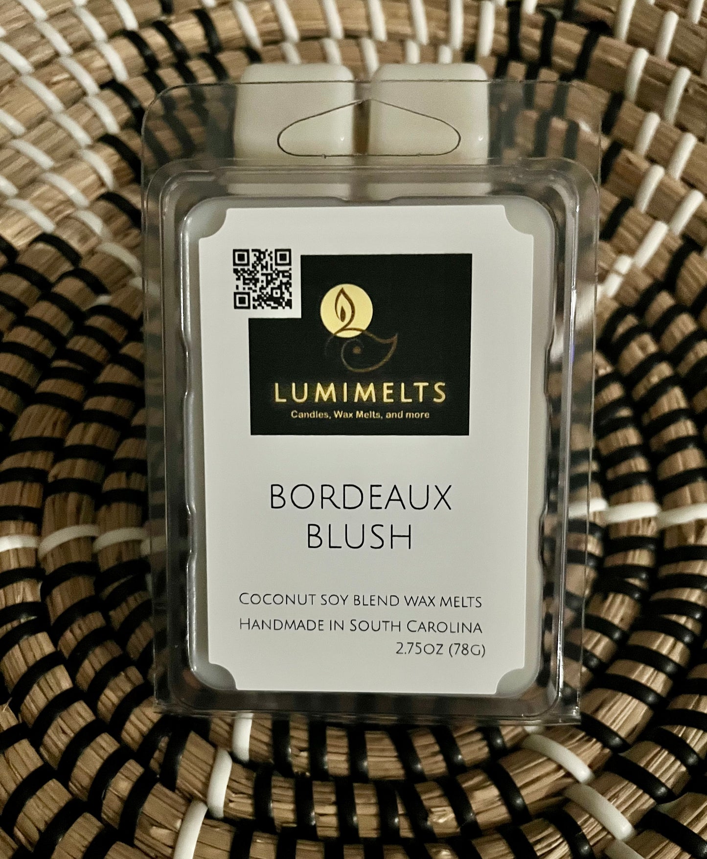 Lumimelts Bordeaux Blush wax melt on a woven surface